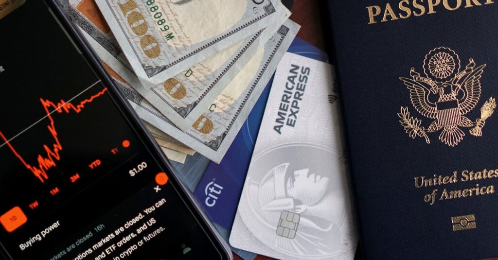 Stock trading concepts with passport, credit cards, cash, and smartphone app image.
