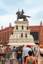 View of Maharaja Ranjit Singh Statue with bustling tourists in Amritsar, India.